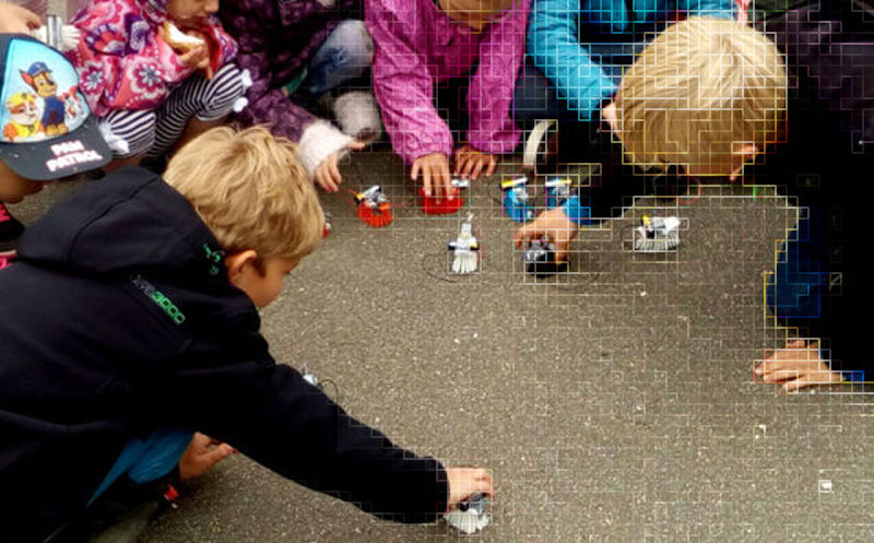 Kids playing with robots